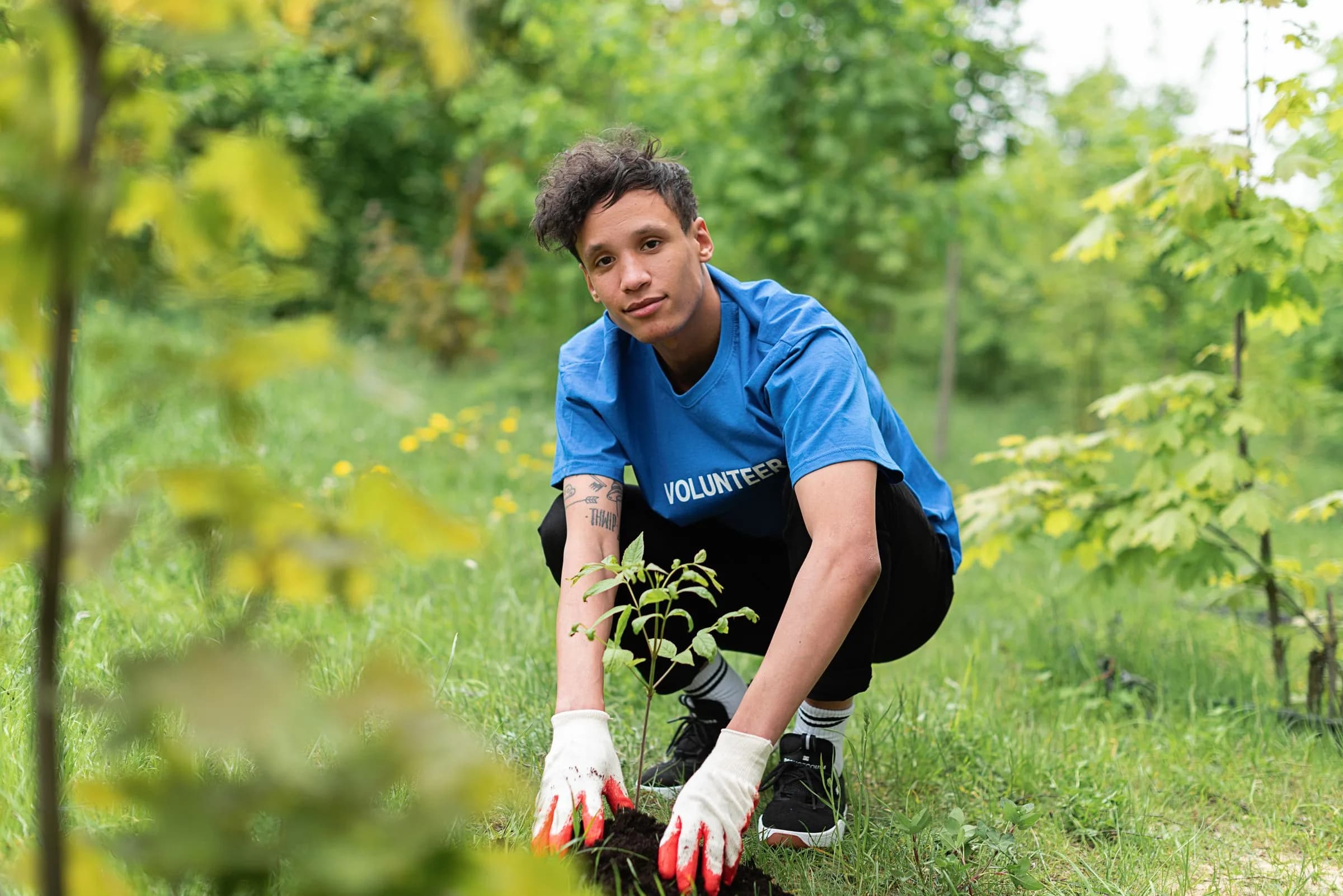 Teen in gloves planting outdoors