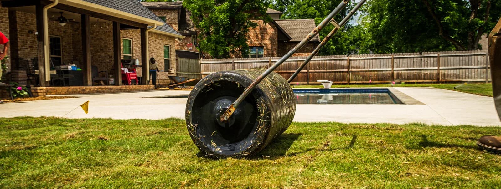 Lawn care equipment on a green backyard lawn